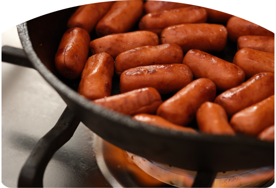 Little smokies in a pan on a gas grill