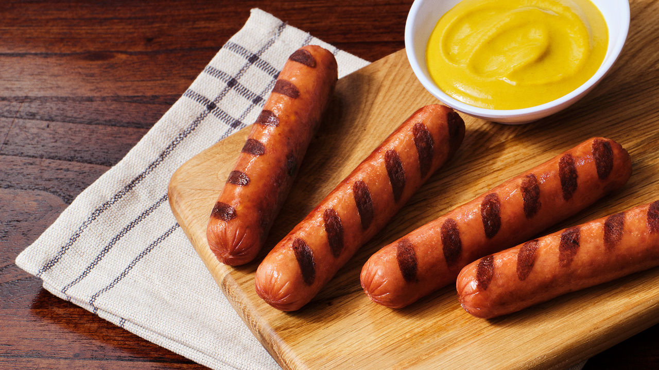Hot dogs on a wooden board 